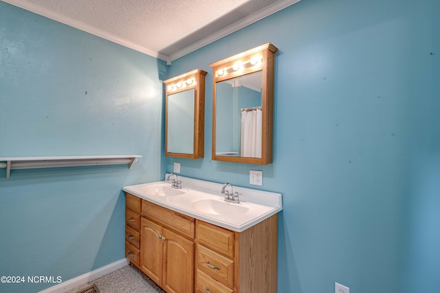 bathroom with vanity, a textured ceiling, and ornamental molding