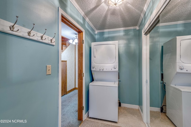 laundry area with ornamental molding, a textured ceiling, and stacked washer / dryer