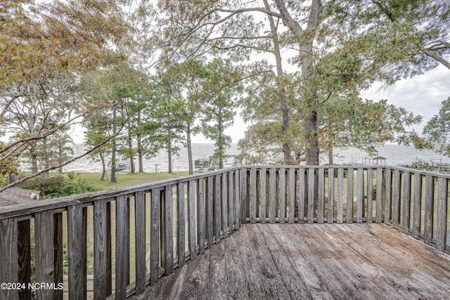 wooden terrace featuring a water view