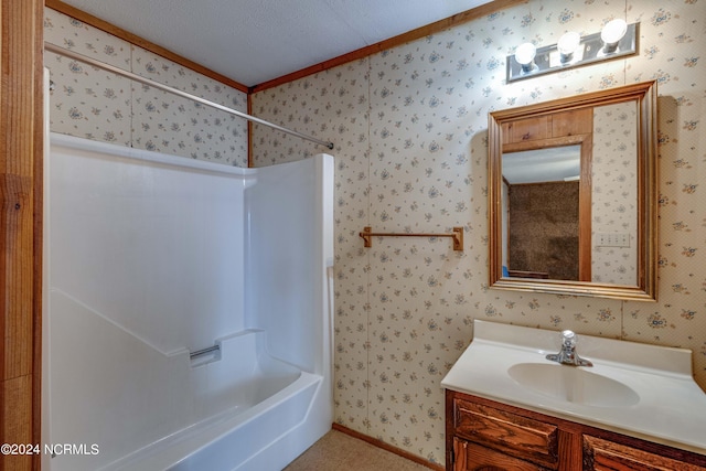 bathroom with vanity, shower / washtub combination, a textured ceiling, and crown molding