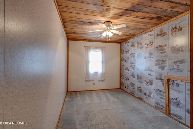 carpeted empty room with wood ceiling and ceiling fan