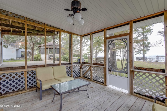 unfurnished sunroom with ceiling fan