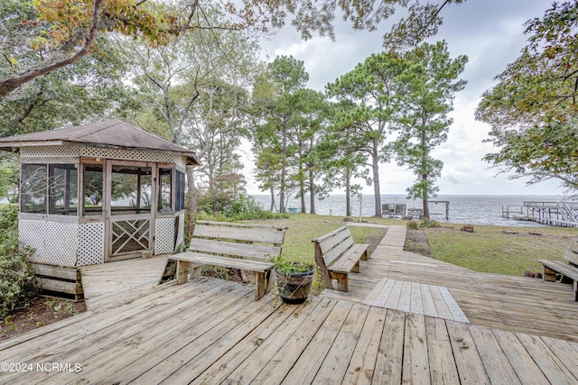 deck featuring a sunroom and a water view