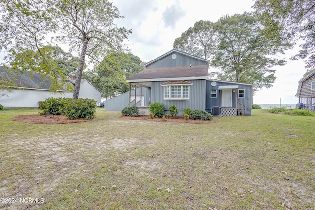 rear view of house featuring a yard