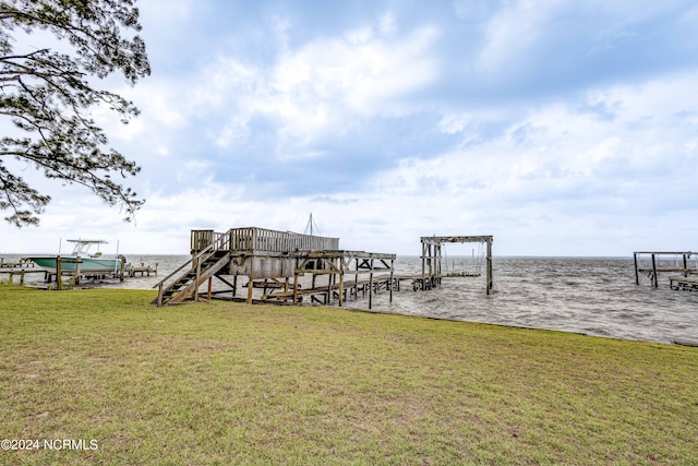 dock area featuring a yard and a water view