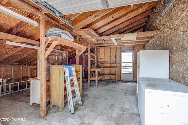 misc room featuring lofted ceiling and concrete floors