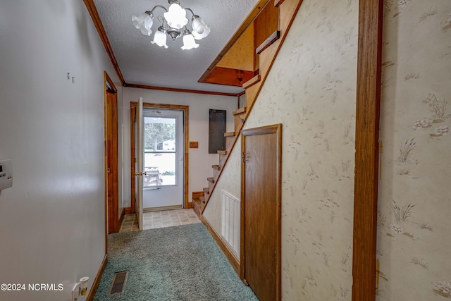 doorway featuring ornamental molding, a notable chandelier, light colored carpet, electric panel, and a textured ceiling