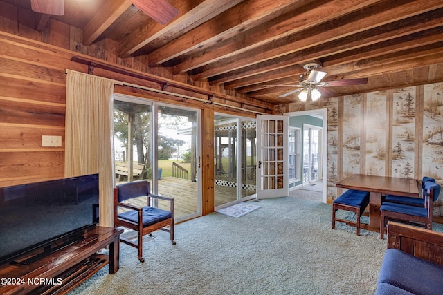 living room featuring french doors, ceiling fan, beamed ceiling, and carpet floors