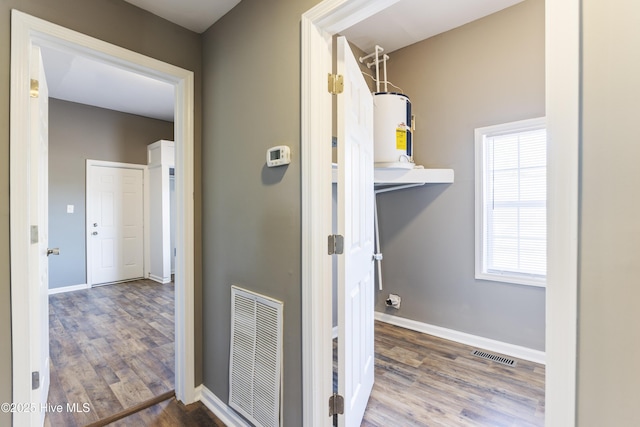 hallway featuring water heater and hardwood / wood-style floors