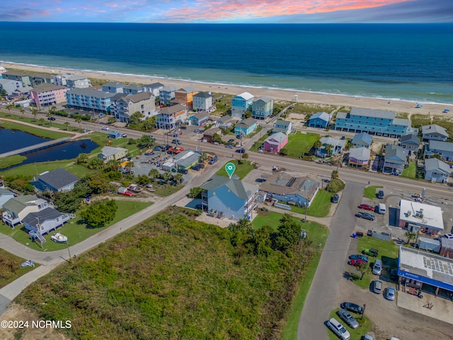 birds eye view of property with a beach view and a water view