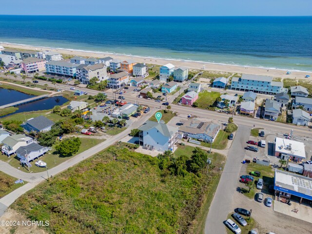 bird's eye view featuring a water view and a view of the beach