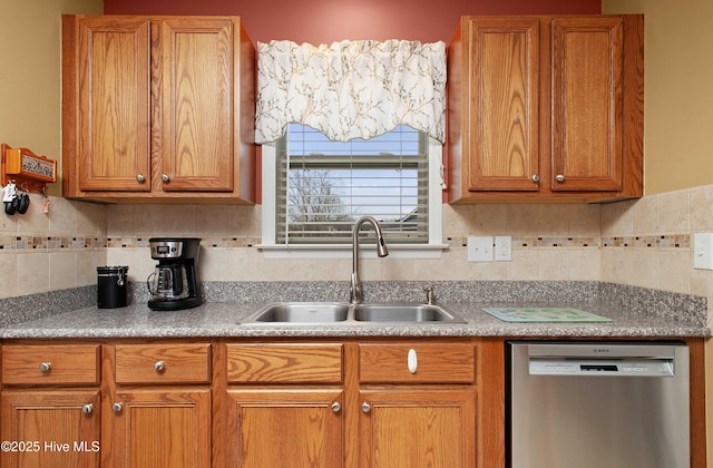 kitchen featuring dishwasher, light countertops, brown cabinetry, and a sink