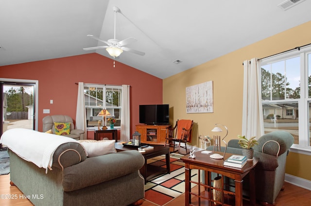 living area featuring light wood-type flooring, visible vents, lofted ceiling, and a ceiling fan