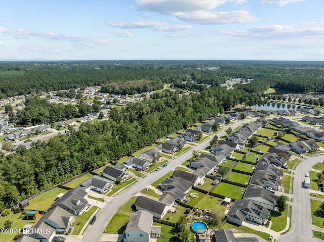 birds eye view of property featuring a residential view, a view of trees, and a water view