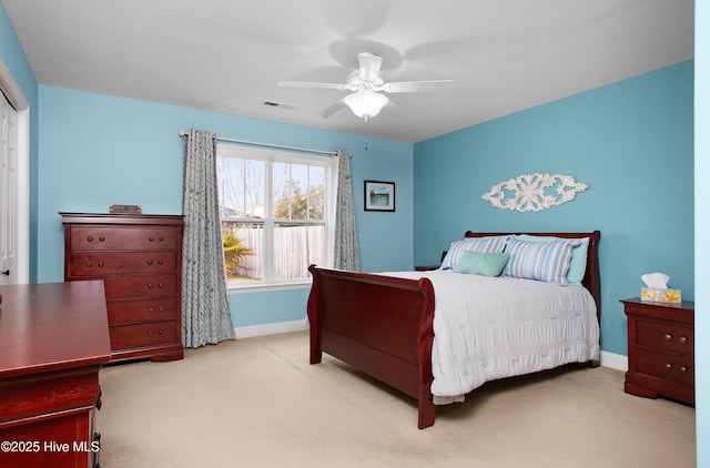 carpeted bedroom featuring a ceiling fan, baseboards, and visible vents