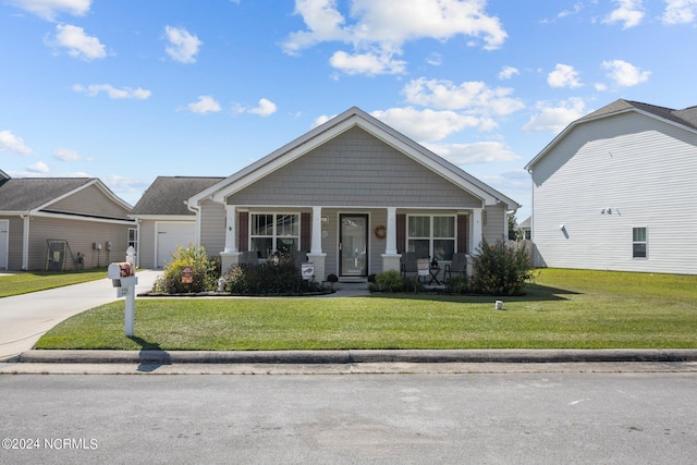 view of front of property with a porch, driveway, and a front lawn