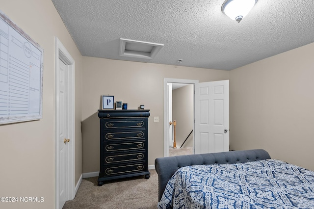 bedroom with light carpet and a textured ceiling