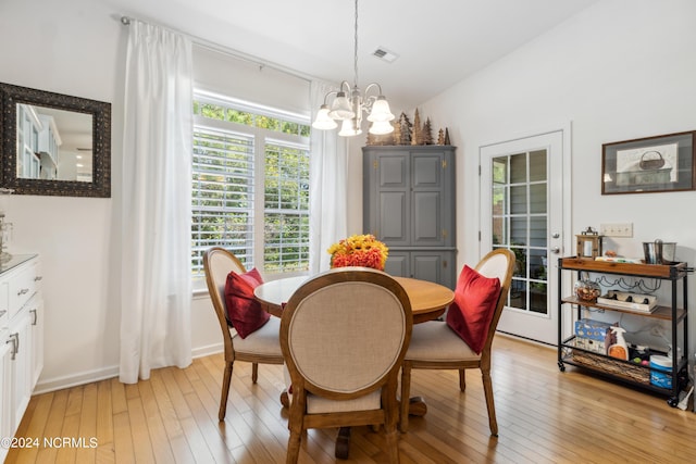 dining room with an inviting chandelier and light hardwood / wood-style floors