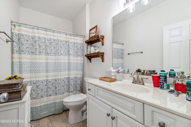 bathroom with vanity, hardwood / wood-style flooring, and toilet