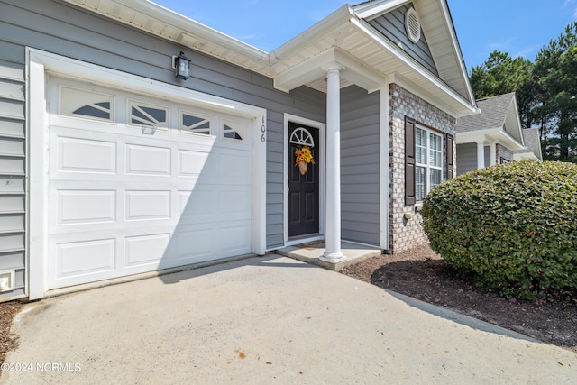 doorway to property with a garage