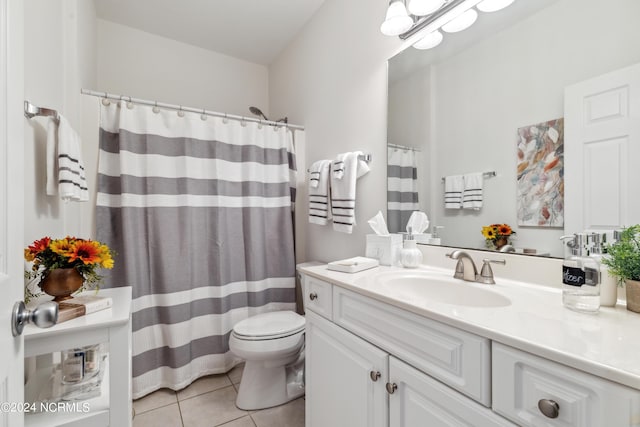 bathroom featuring tile patterned floors, toilet, and vanity