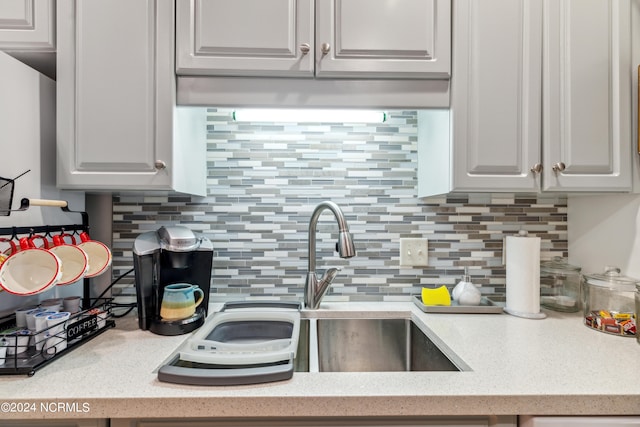 kitchen with backsplash and white cabinets