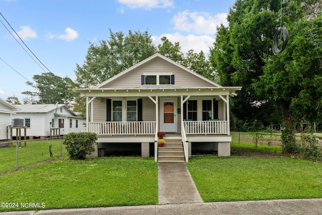 view of front of house featuring covered porch and a front lawn