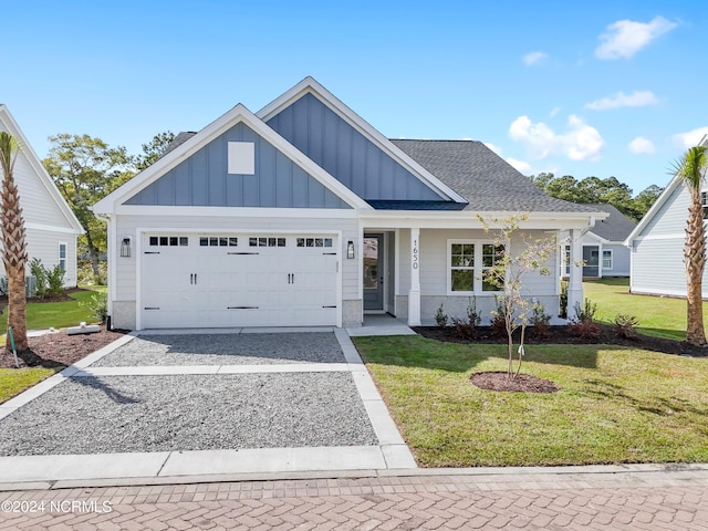 1650 Back Bay Dr SW Unit L-48, Shallotte, NC 28470 - view of front facade featuring gravel driveway, board and batten siding, an attached garage, a front yard, and a shingled roof