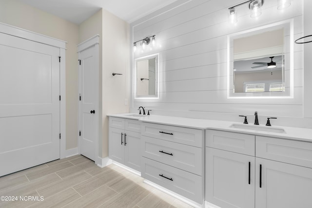 1650 Back Bay Dr SW Unit L-48, Shallotte, NC 28470 - full bath featuring wood finish floors, double vanity, ceiling fan, and baseboards