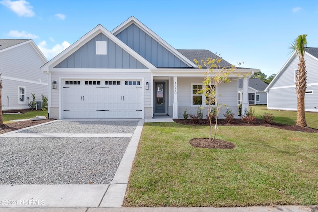 view of front of house featuring covered porch, a front lawn, and a garage