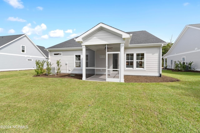 back of house with a yard, a sunroom, and ceiling fan