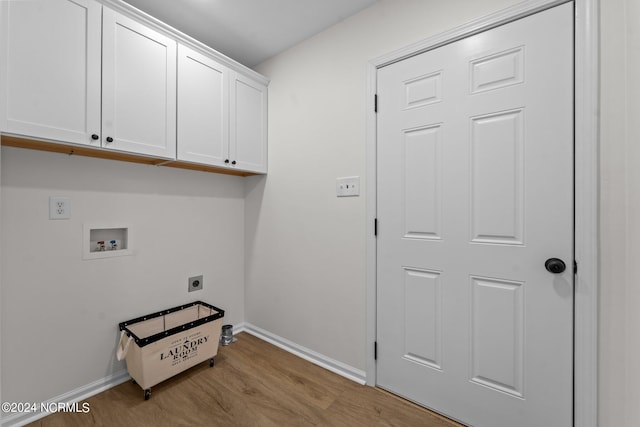 clothes washing area featuring hookup for a washing machine, light hardwood / wood-style floors, electric dryer hookup, and cabinets