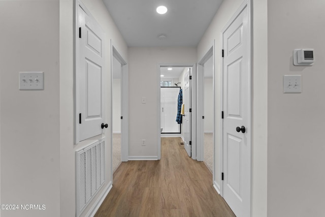 corridor with light hardwood / wood-style flooring