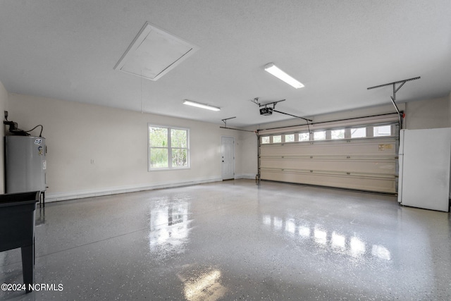 garage with white fridge, a garage door opener, and water heater