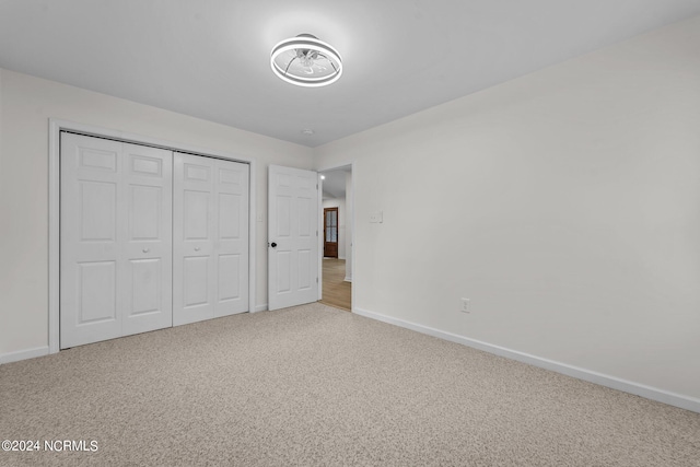 unfurnished bedroom featuring a closet and carpet floors