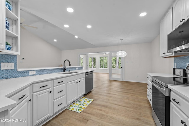 kitchen featuring decorative backsplash, sink, pendant lighting, white cabinetry, and appliances with stainless steel finishes