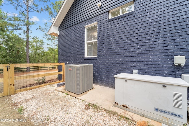 view of side of home with central air condition unit