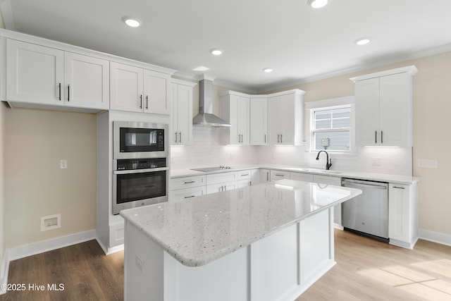 1645 Old Salt Run SW Unit L-46, Shallotte, NC 28470 - kitchen featuring stainless steel appliances, wall chimney exhaust hood, a sink, decorative backsplash, and recessed lighting