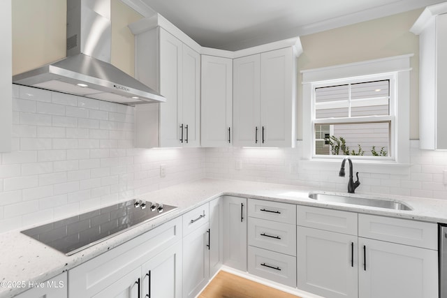 1645 Old Salt Run SW Unit L-46, Shallotte, NC 28470 - kitchen with wall chimney exhaust hood, black electric cooktop, a sink, decorative backsplash, and white cabinets