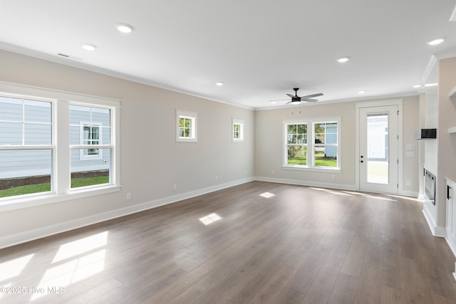 1645 Old Salt Run SW Unit L-46, Shallotte, NC 28470 - unfurnished living room with a ceiling fan, baseboards, crown molding, a glass covered fireplace, and dark wood finished floors