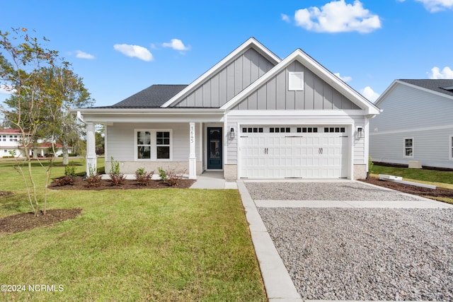 view of front of house with a front lawn, covered porch, board and batten siding, concrete driveway, and an attached garage