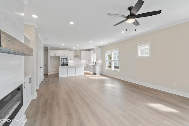 1645 Old Salt Run SW Unit L-46, Shallotte, NC 28470 - unfurnished living room featuring crown molding, baseboards, a ceiling fan, light wood finished floors, and recessed lighting