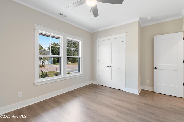 1645 Old Salt Run SW Unit L-46, Shallotte, NC 28470 - unfurnished bedroom featuring ornamental molding, light wood-type flooring, baseboards, and a ceiling fan