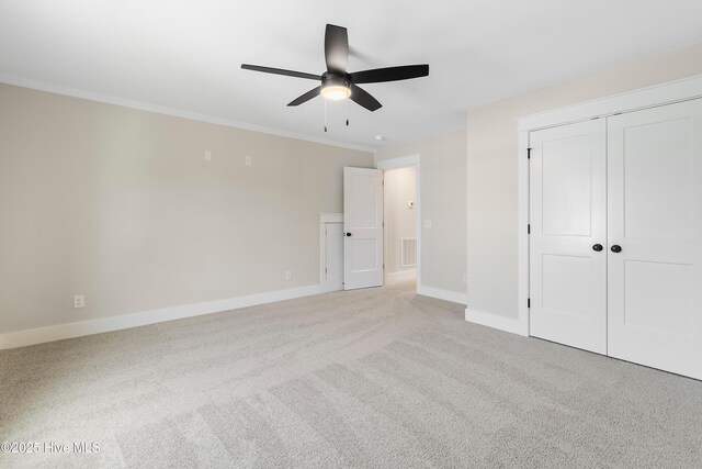 1645 Old Salt Run SW Unit L-46, Shallotte, NC 28470 - unfurnished bedroom with light colored carpet, baseboards, crown molding, a closet, and a ceiling fan