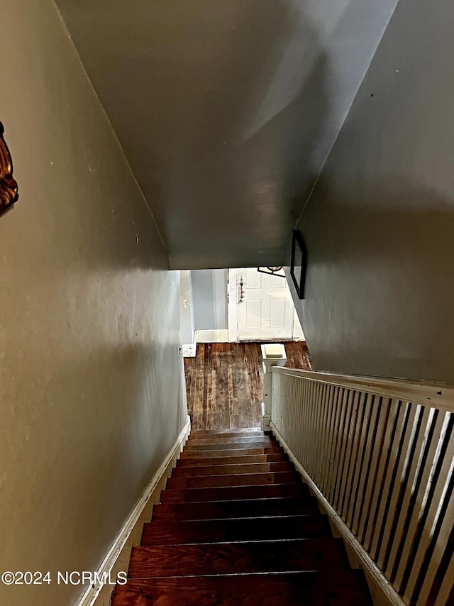 stairway featuring wood-type flooring