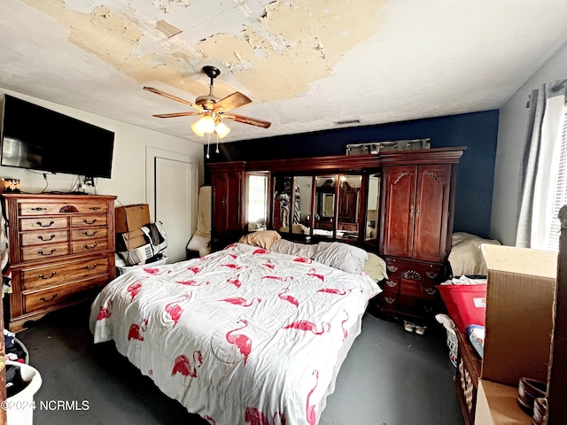 bedroom featuring ceiling fan and concrete floors