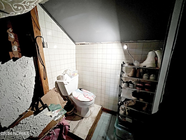 bathroom with tile walls and toilet