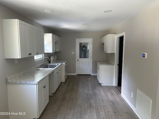 kitchen with light hardwood / wood-style flooring, white stove, sink, and white cabinets