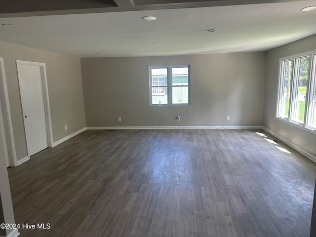 empty room with dark wood-type flooring