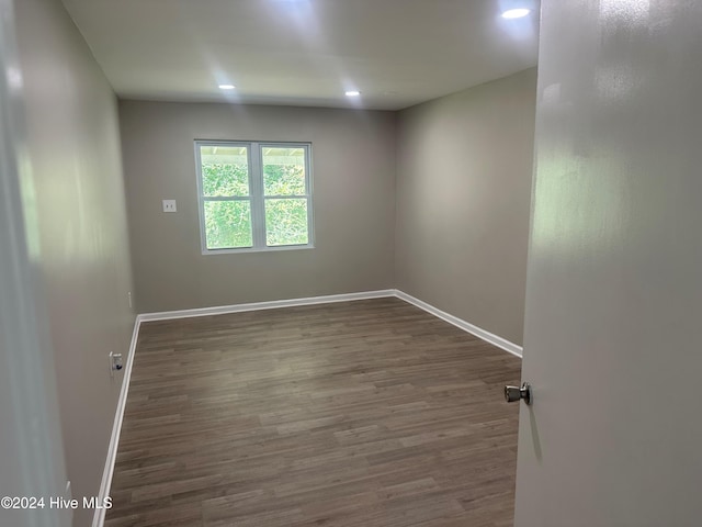 empty room with dark hardwood / wood-style floors